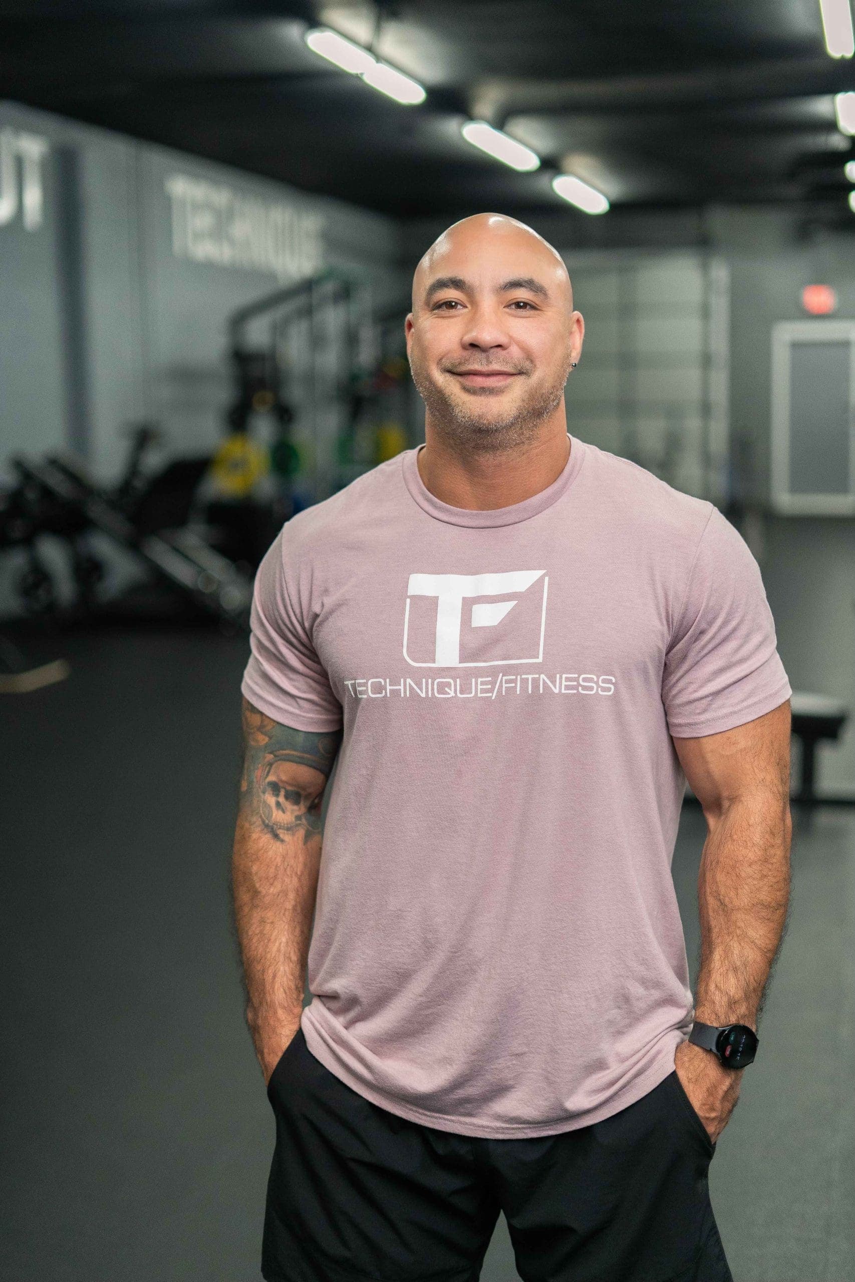 A Technique Fitness coach guiding a client through a lift